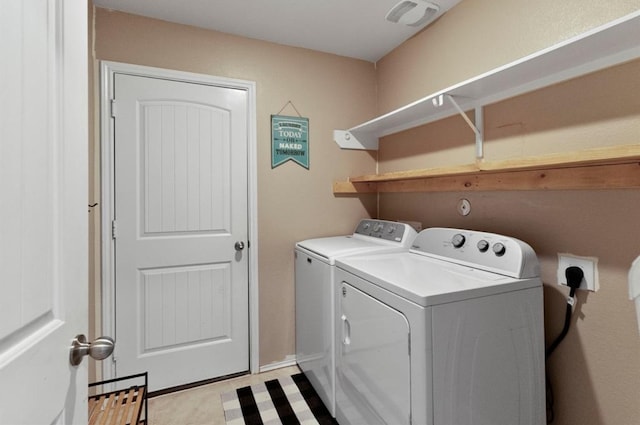 clothes washing area with washer and clothes dryer