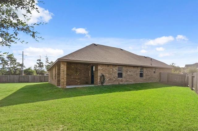 back of property featuring a lawn