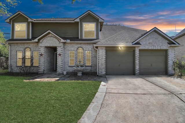 view of front facade with a garage and a lawn