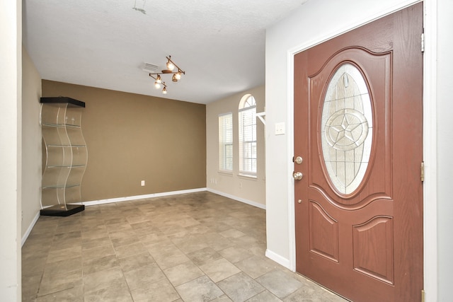 foyer featuring a textured ceiling