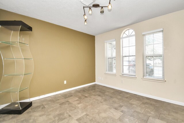 empty room with a textured ceiling