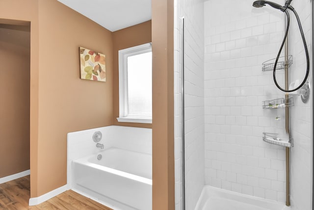 bathroom with hardwood / wood-style floors and shower with separate bathtub