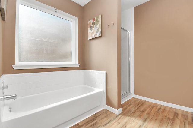 bathroom featuring wood-type flooring and independent shower and bath