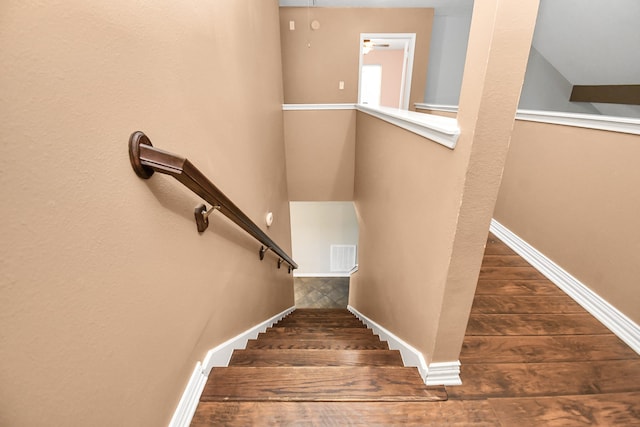 stairway featuring wood-type flooring