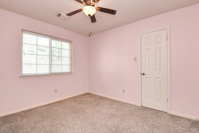 carpeted spare room with ceiling fan