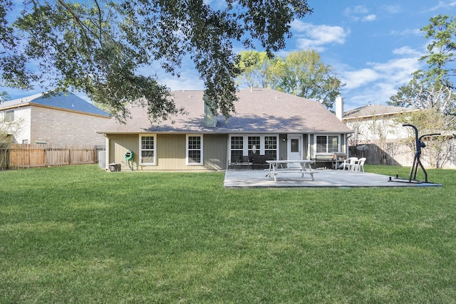 back of property with a patio area and a yard