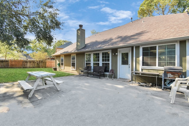 back of house featuring a yard and a patio