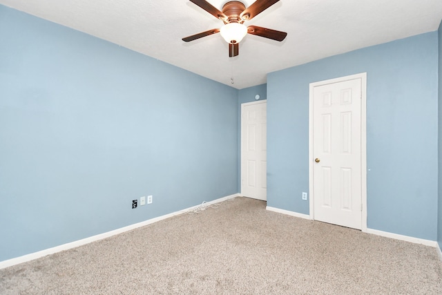 unfurnished bedroom with ceiling fan and carpet