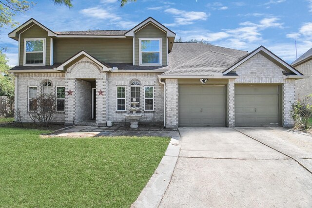 view of front facade with a front yard and a garage