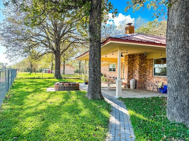 view of yard with a fire pit and a patio area