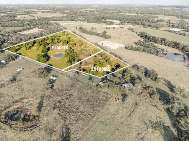 birds eye view of property featuring a rural view and a water view