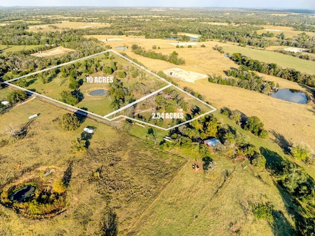 drone / aerial view featuring a water view and a rural view