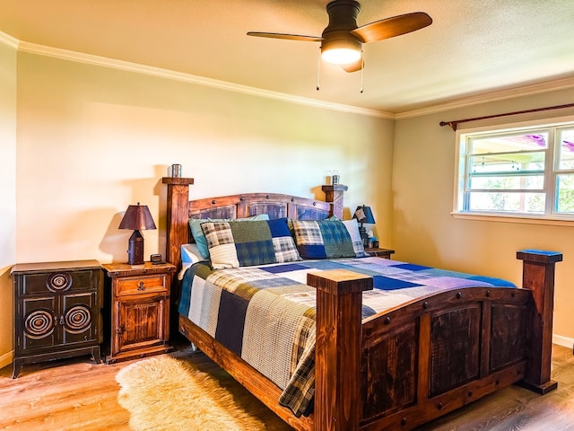 bedroom featuring hardwood / wood-style floors, ceiling fan, and ornamental molding