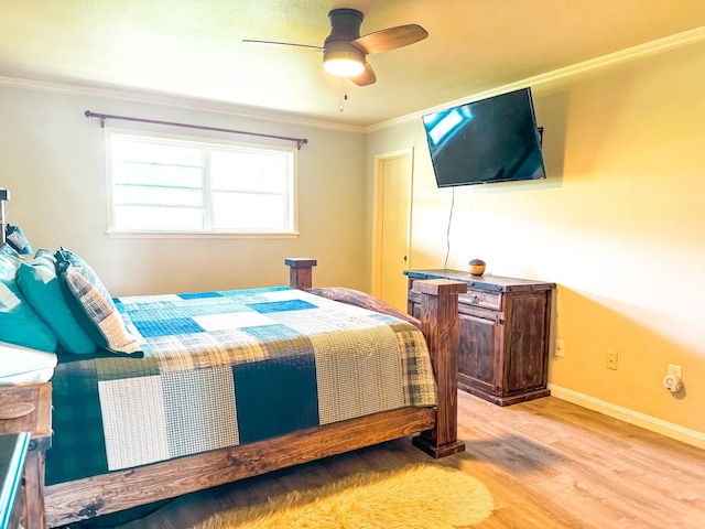 bedroom featuring light hardwood / wood-style flooring, ceiling fan, and ornamental molding