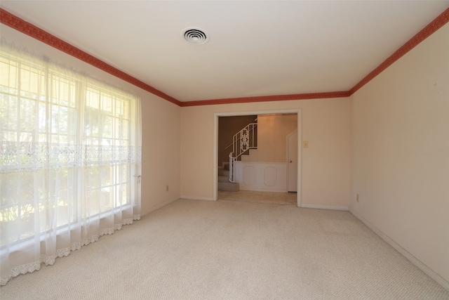 carpeted empty room with ornamental molding