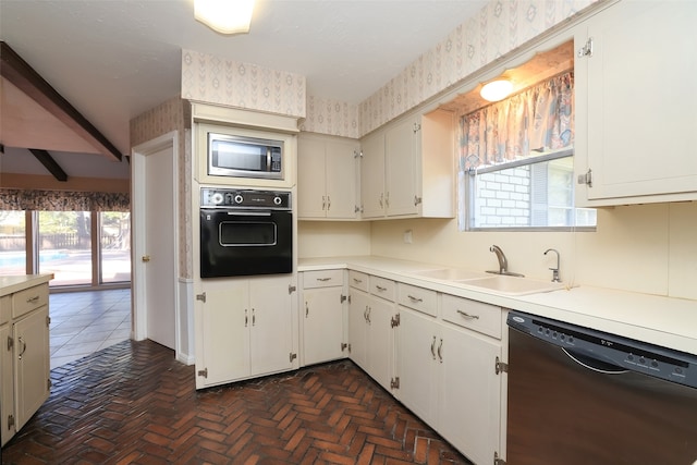 kitchen with white cabinetry, sink, and black appliances