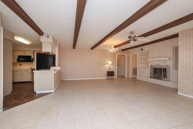 unfurnished living room with beam ceiling, ceiling fan with notable chandelier, a brick fireplace, and light parquet flooring