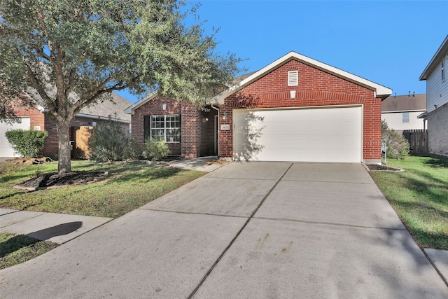 view of front of property featuring a garage and a front lawn