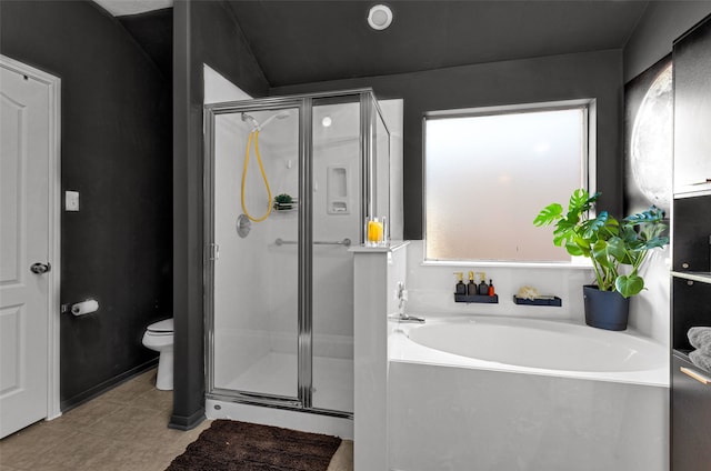 bathroom featuring toilet, tile patterned floors, and separate shower and tub