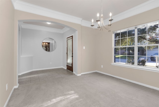 carpeted empty room with crown molding and a chandelier