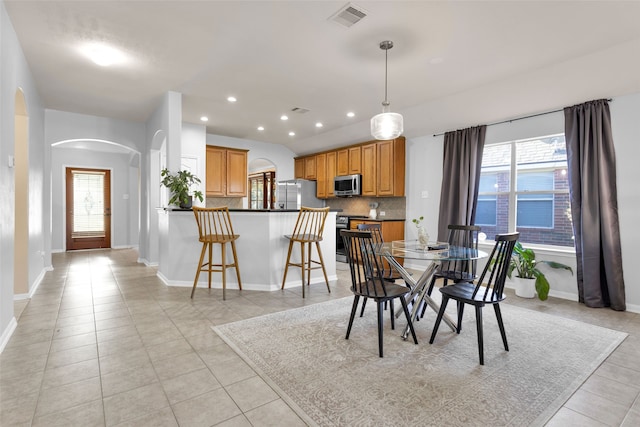 dining area with light tile patterned floors and a healthy amount of sunlight