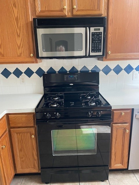 kitchen with decorative backsplash, dishwasher, and black range with gas cooktop