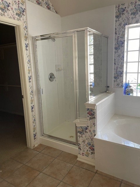 bathroom featuring separate shower and tub and vaulted ceiling