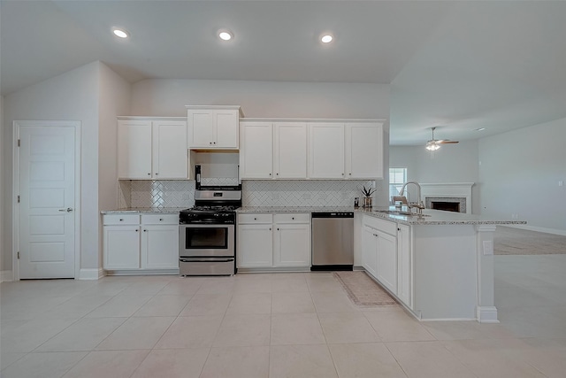 kitchen featuring white cabinets, stainless steel appliances, and kitchen peninsula