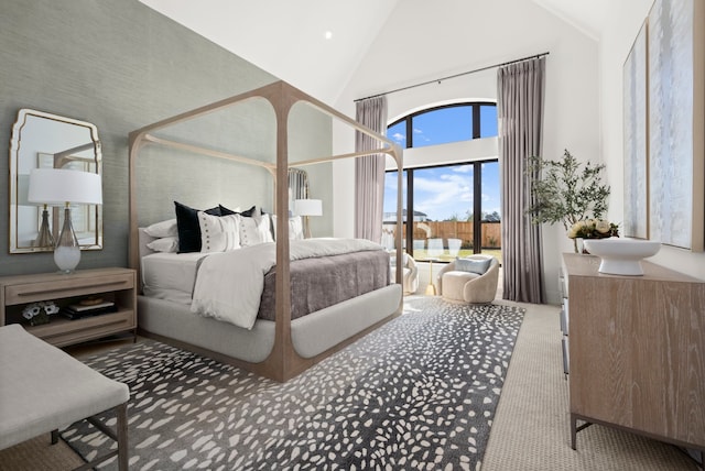 carpeted bedroom featuring high vaulted ceiling