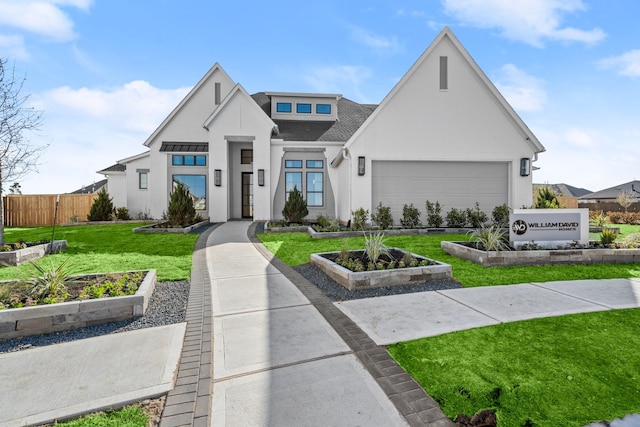 view of front facade with a garage and a front lawn