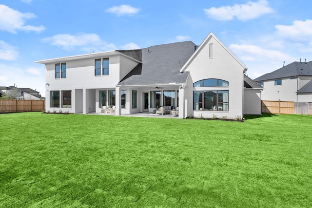 rear view of house featuring a lawn, ceiling fan, and a patio