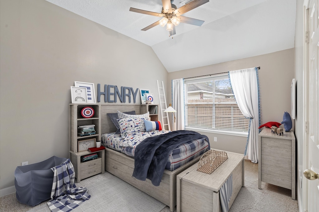 carpeted bedroom with ceiling fan and lofted ceiling