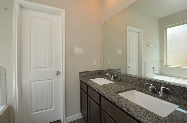 bathroom featuring vanity and a bath