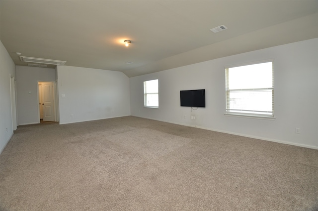 unfurnished room with light carpet and lofted ceiling