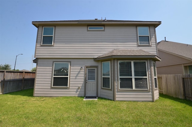 back of house featuring a yard