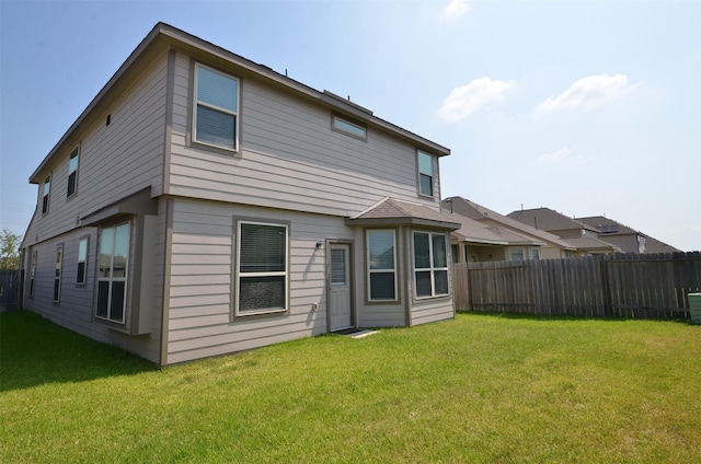 back of house with a yard