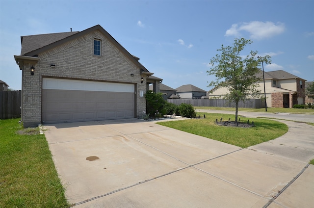 view of front of house featuring a front yard and a garage