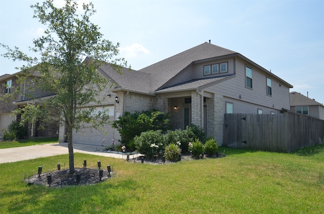 view of front facade featuring a garage and a front lawn