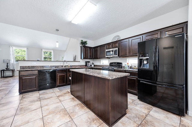 kitchen featuring a textured ceiling, dark brown cabinetry, black appliances, decorative light fixtures, and lofted ceiling