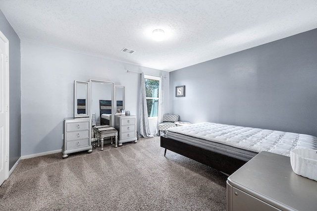 carpeted bedroom with a textured ceiling