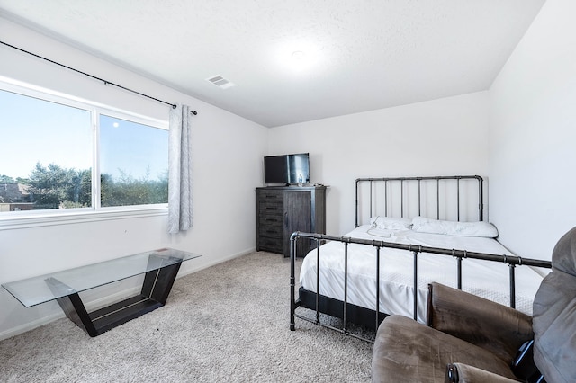 carpeted bedroom featuring a textured ceiling