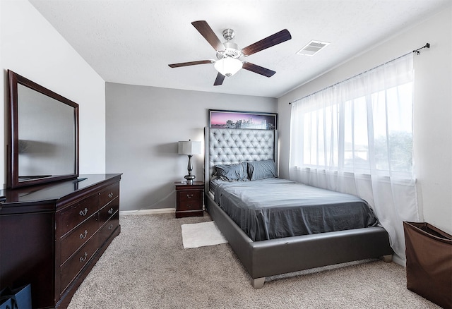 bedroom featuring carpet, ceiling fan, and a textured ceiling