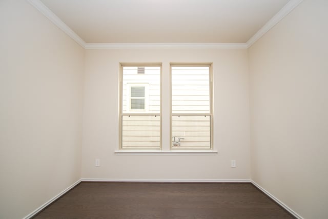 spare room featuring crown molding and dark wood-type flooring