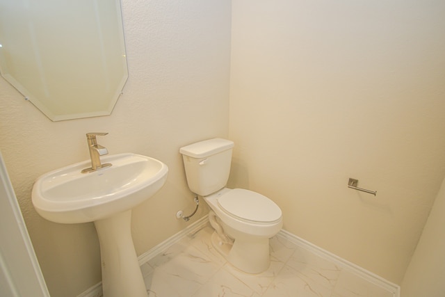 bathroom with sink and toilet