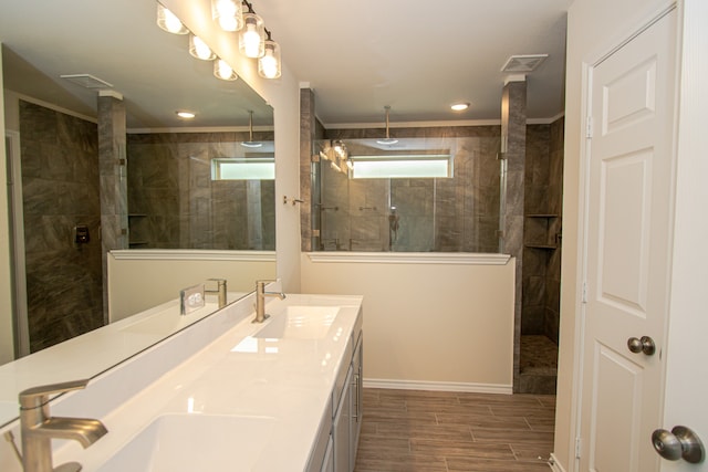 bathroom featuring a tile shower and vanity