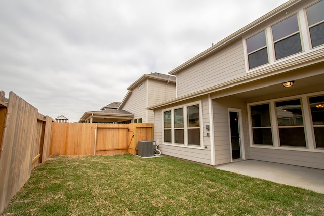 view of yard featuring central AC and a patio