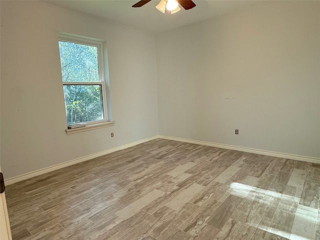 spare room featuring light wood-type flooring and ceiling fan