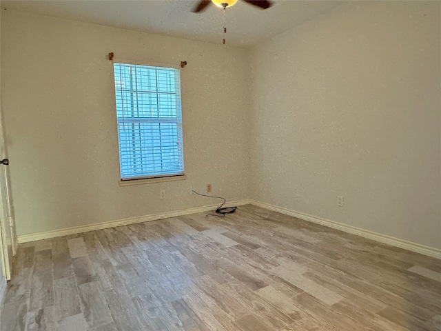 spare room featuring ceiling fan and light wood-type flooring