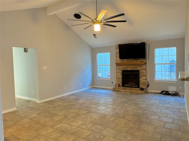 unfurnished living room with beam ceiling, ceiling fan, a fireplace, and high vaulted ceiling