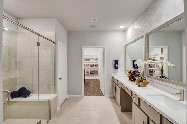 bathroom with tile patterned floors, vanity, and walk in shower